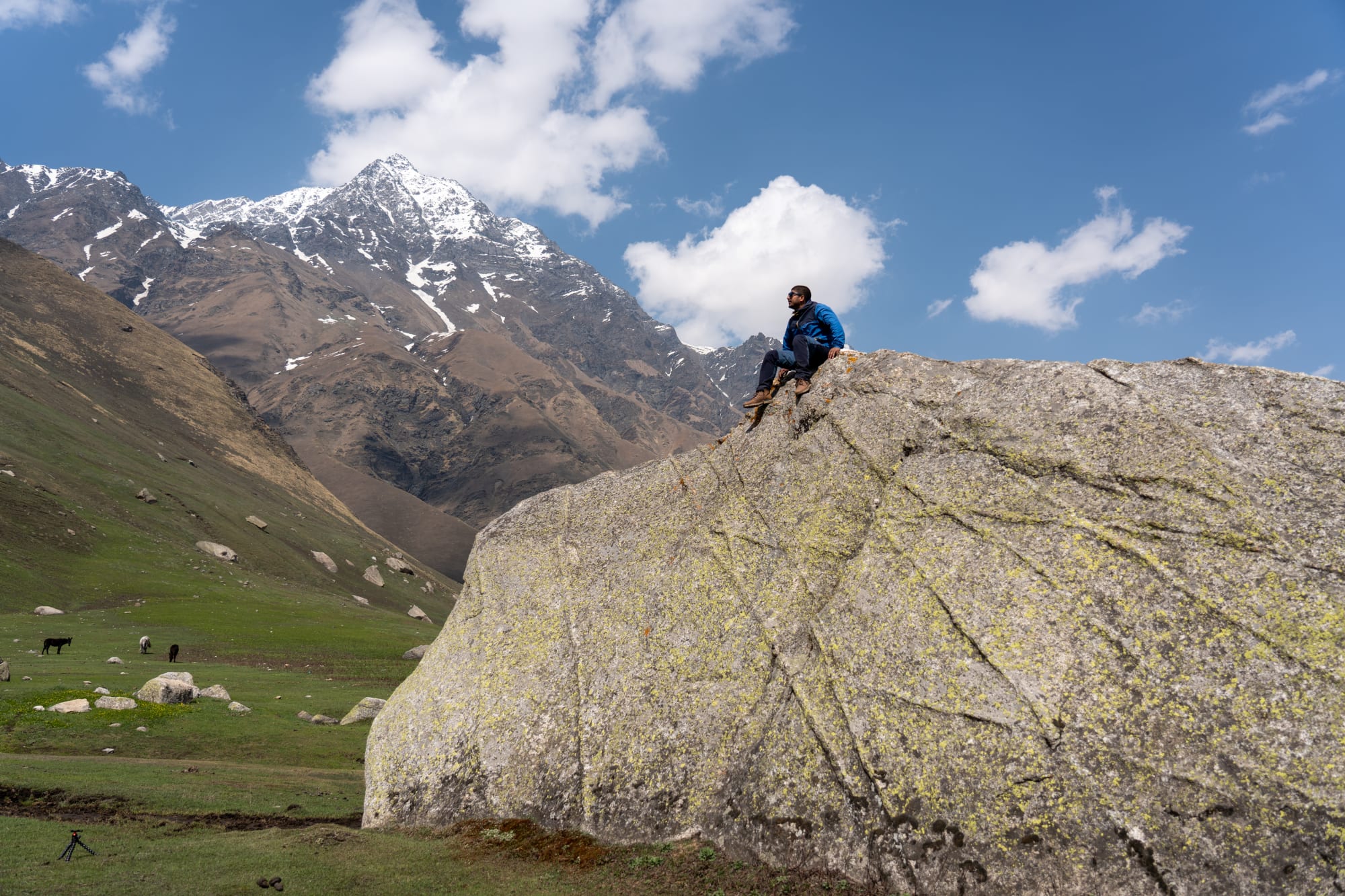 a person on a huge rock at Kara lake in Bhaba valley