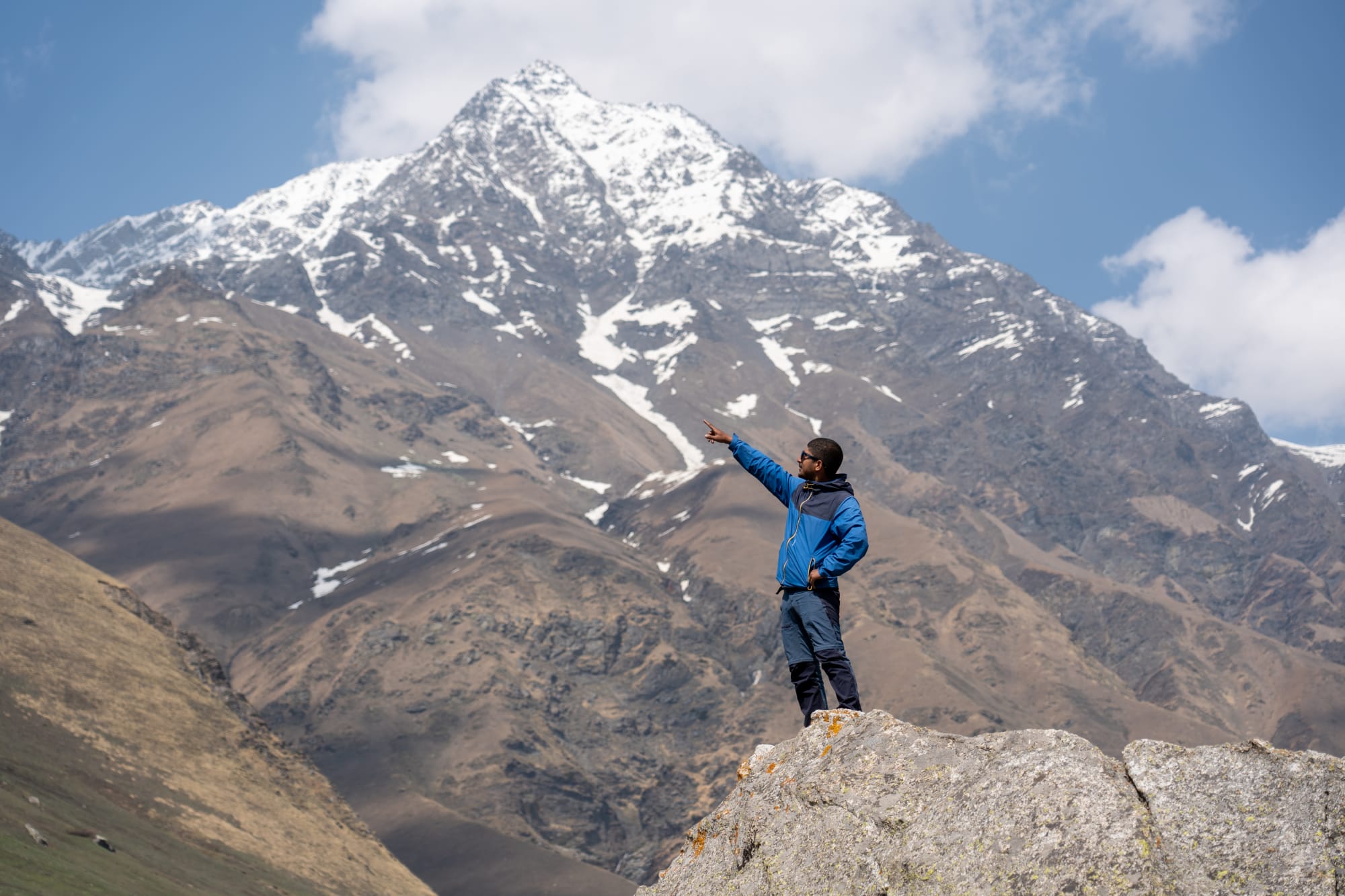 a person on a huge rock at Kara lake in Bhaba valley