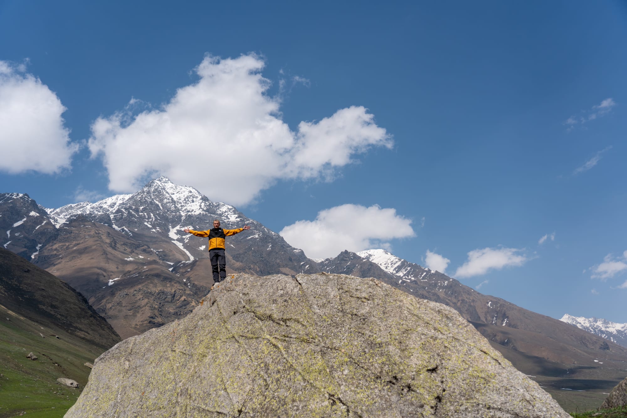 a person on a huge rock at Kara lake in Bhaba valley