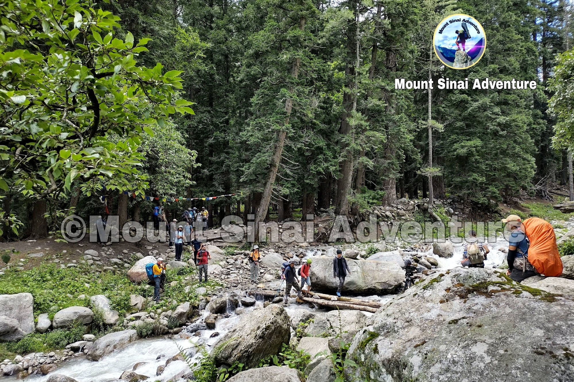 a group of people crossing the river in Bhaba valley (Kinnaur)