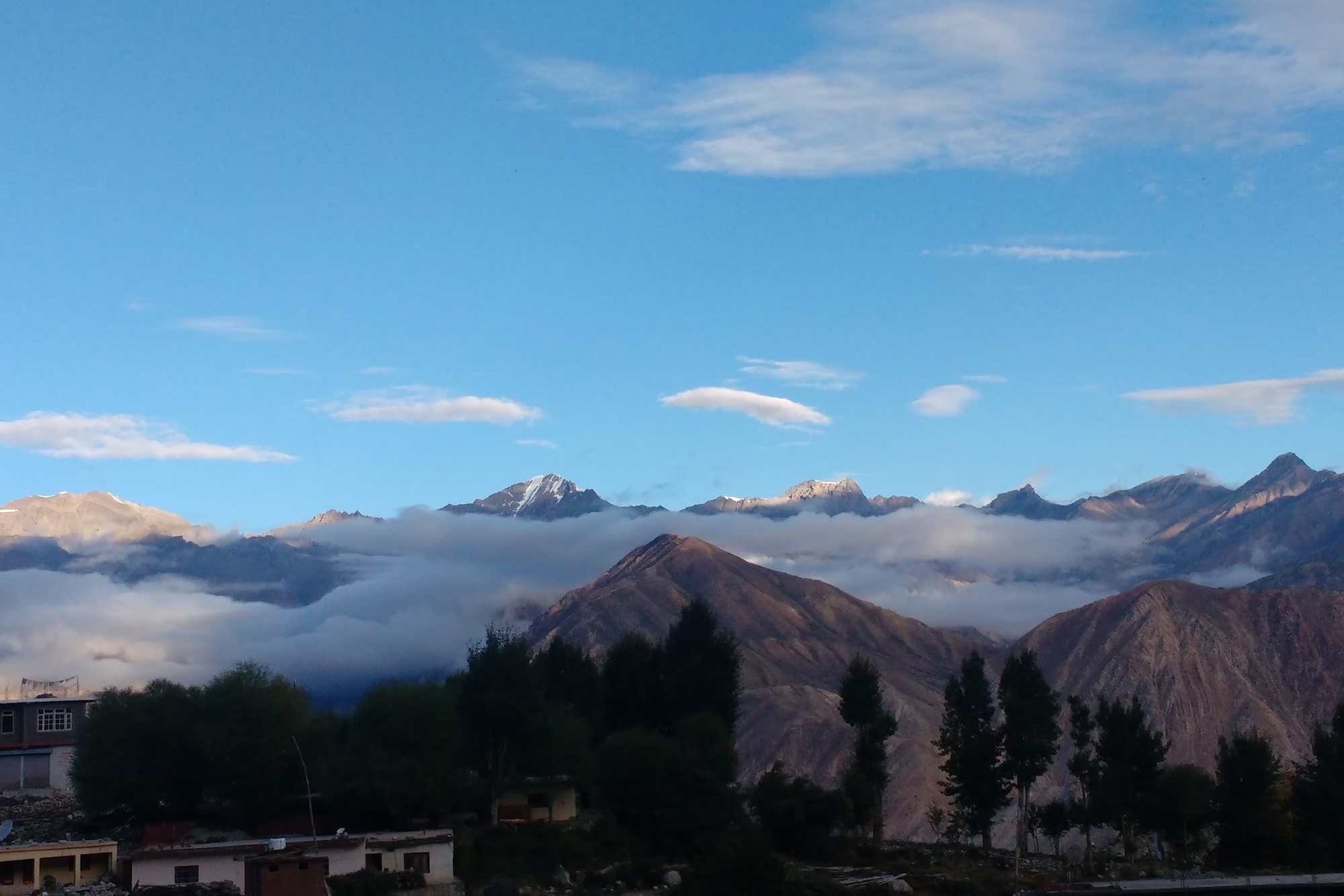 Himalayan mountains with blue sky and some fogy clouds