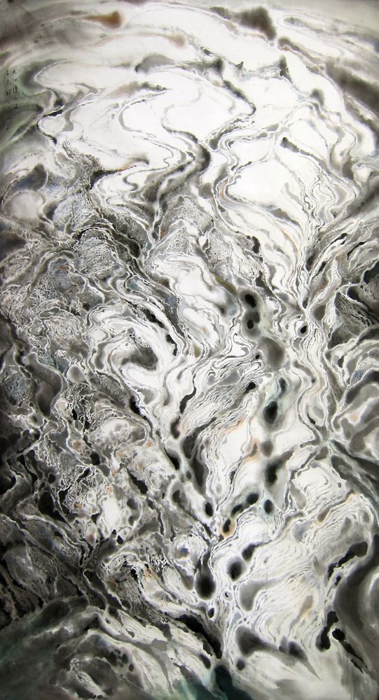 Ink and colour paint spread along a vertical silk surface make rippling lines of black and grey against a whitish background. Some of the ripples converge into small, dark blobs before they unravel towards the upper section.