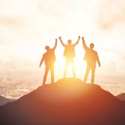 3 people watching sunset on mountain