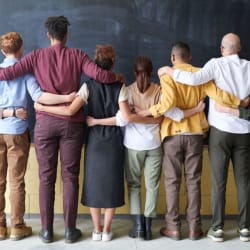 row of 6 people holding each other