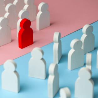 cutout of people in white with one red