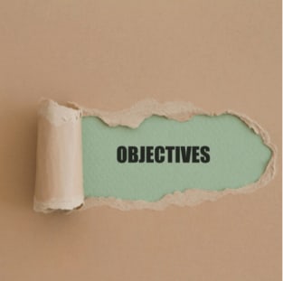 torn paper revealing a word objective