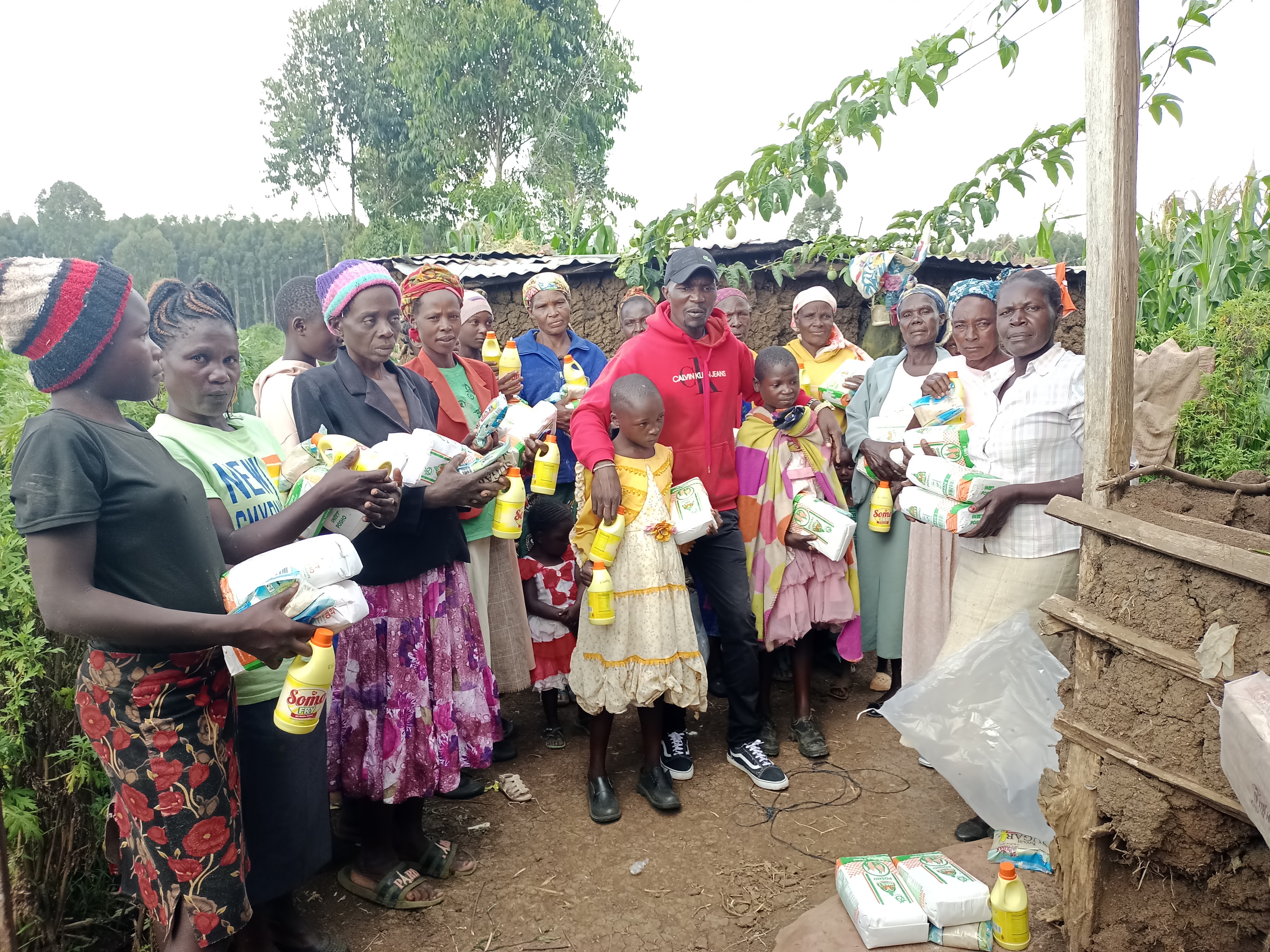 Praying with widows during food donation