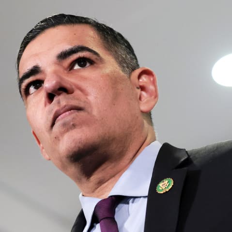 In this photo that was shot from below, Robert Garcia points his left index finger at something or someone. He looks at the same direction.