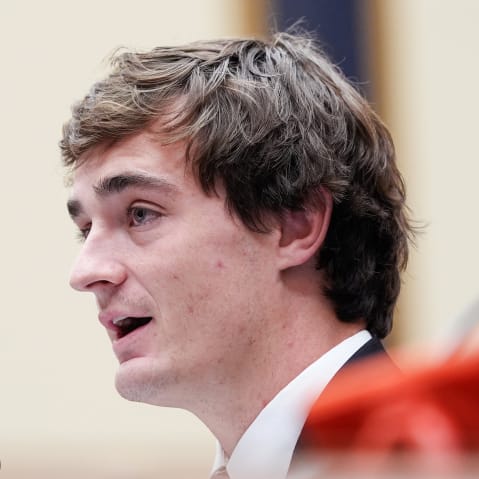 In this very tight shot, Nick Shirley is seen from the side while speaking.