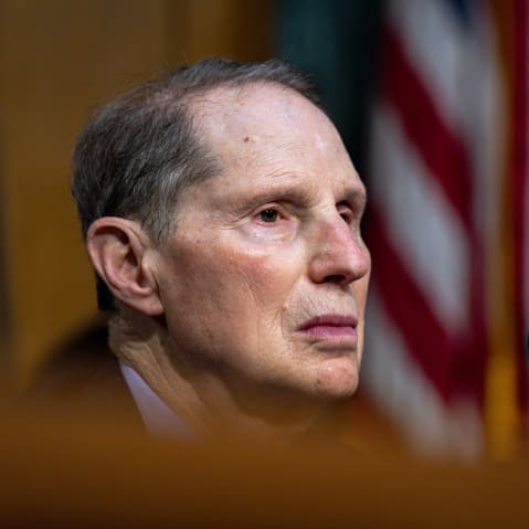 This close up shot shows Ron Wyden sitting as he speaks.