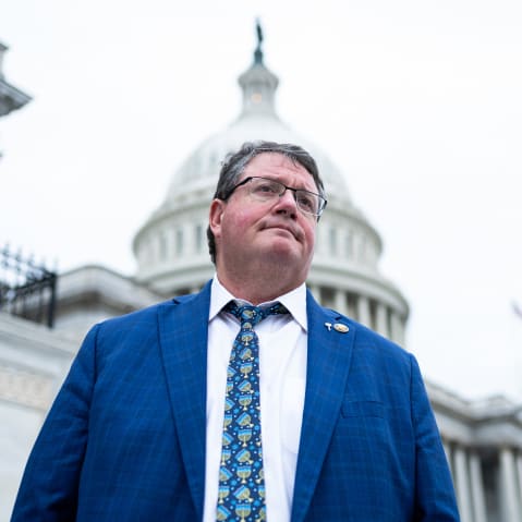 Randy Fine looks on as he is photographed from below in front of the capitol building.