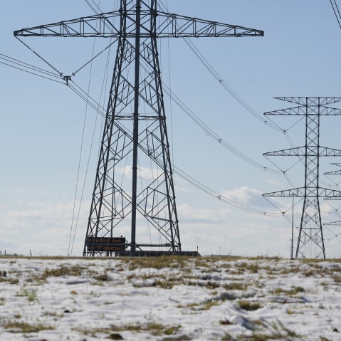 Transmission lines with snow on the ground are shown along the North Sam Houston Parkway near SH249.
