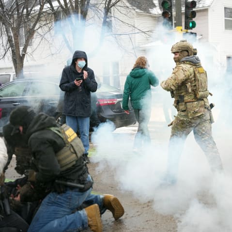 Tear gas is deployed as Federal agents make arrests on Jan. 21, 2026, in Minneapolis.