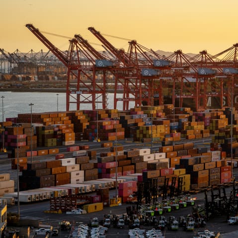 Shipping containers seen in a wide shot at sunset.