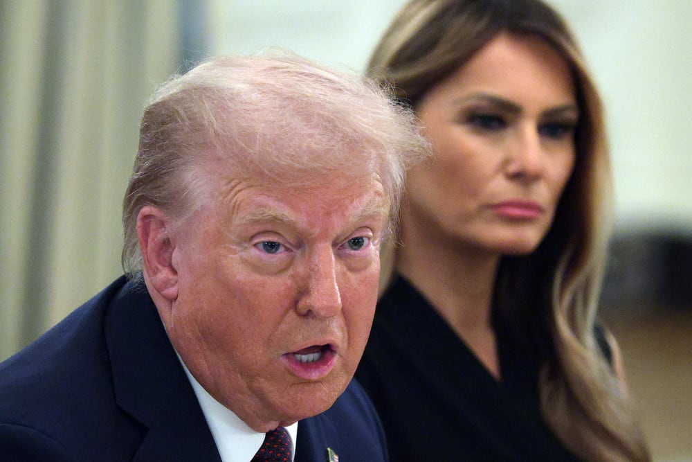 President Donald Trump speaks as first lady Melania Trump listens on Sept. 4, 2025, during a dinner at the State Dining Room of the White House.