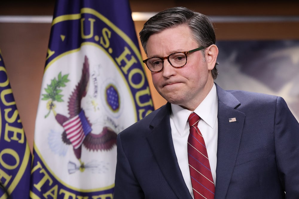 Mike Johnson walking to the podium looking upset.