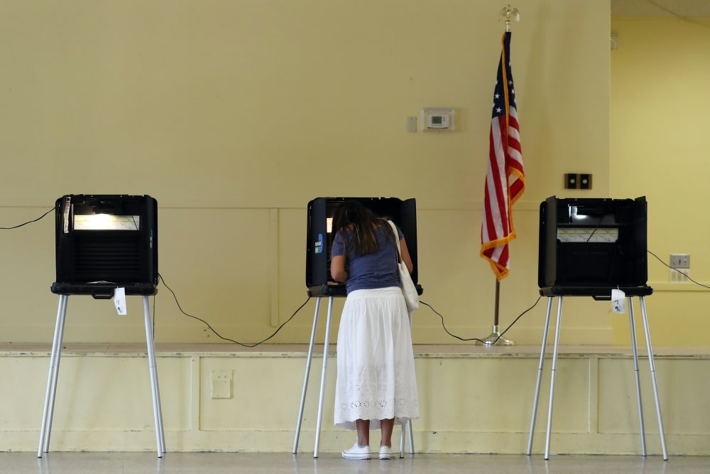 Woman fills out her ballot as she votes on Nov. 03, 2020 in Miami.