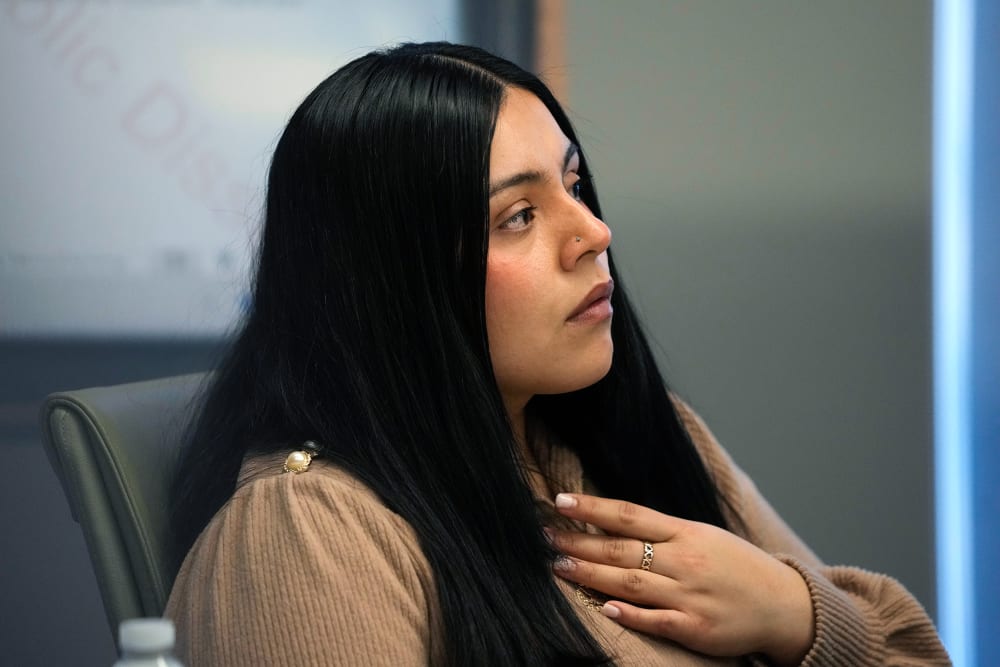 Marimar Martinez sits while her left hand rests on her chest.