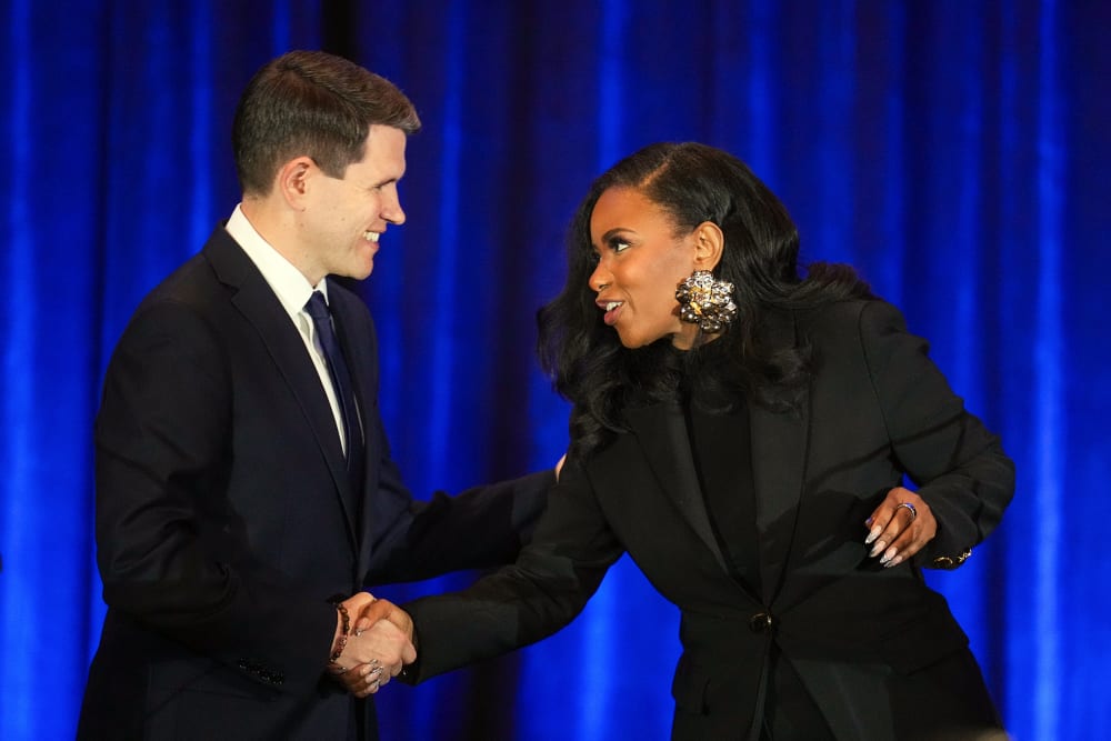 State Representative James Talarico and Representative Jasmine Crockett shake hands during a debate.