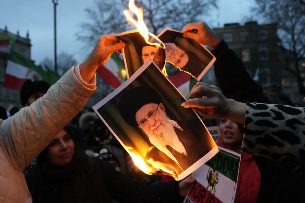 Protestors burn images of Ayatollah Ali Khamenei during a rally on Jan. 11, 2026 in central London.