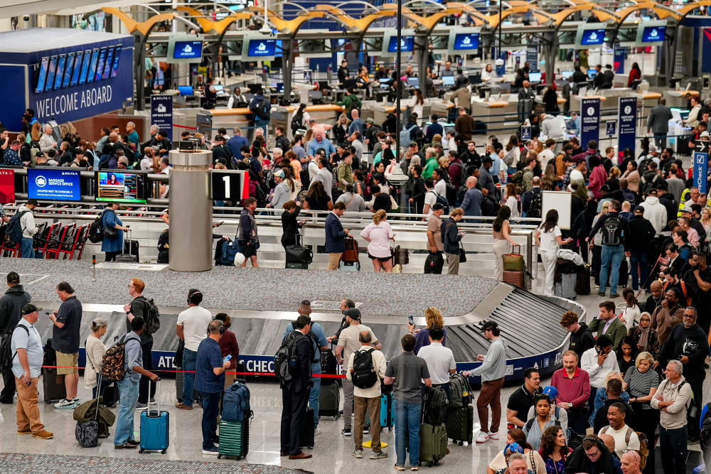 People wait in long lines at the airport.