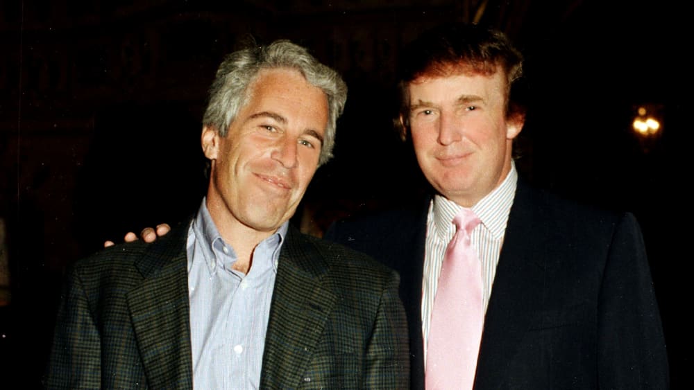 Epstein and Trump pose for a portrait together while Trump has his right hand over Epstein's shoulder.
