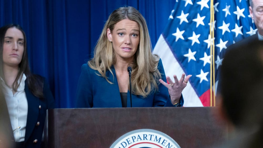 Tricia McLaughlin gestures with her hand as he speaks during a presser.