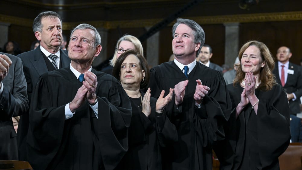 SCOTUS justices applaud as they stand.