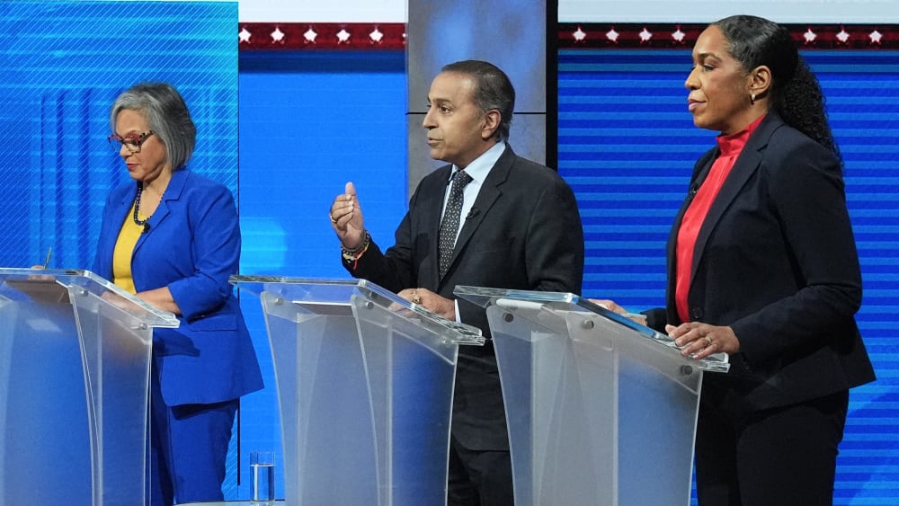 (From left to right) Robin Kelly, Raja Krishnamoorthi and Juliana Stratton stand behind indiviual podiums.