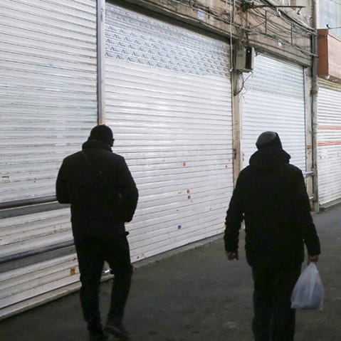 People walk through an empty marketplace with closed vendors; Ali Velshi.