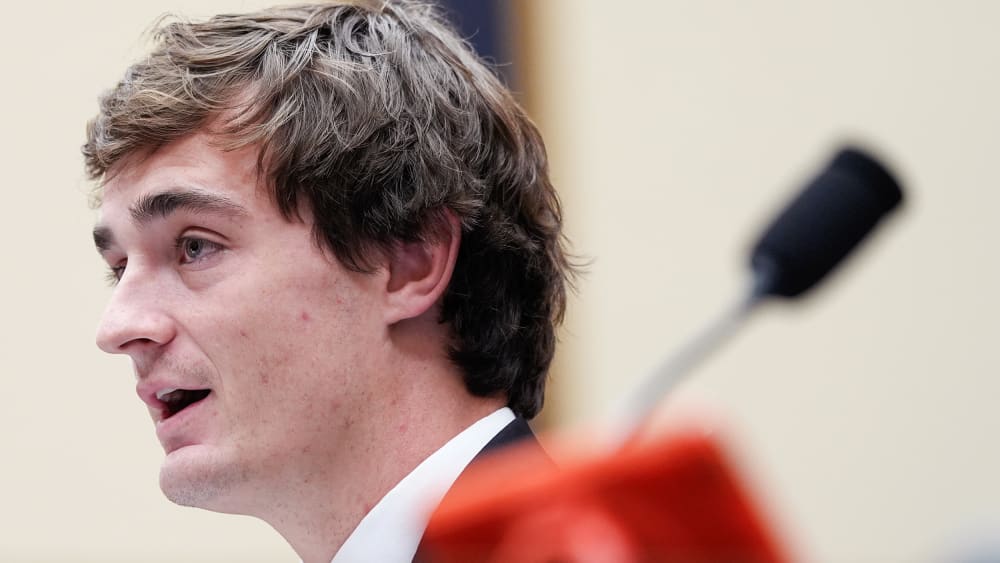 In this very tight shot, Nick Shirley is seen from the side while speaking.