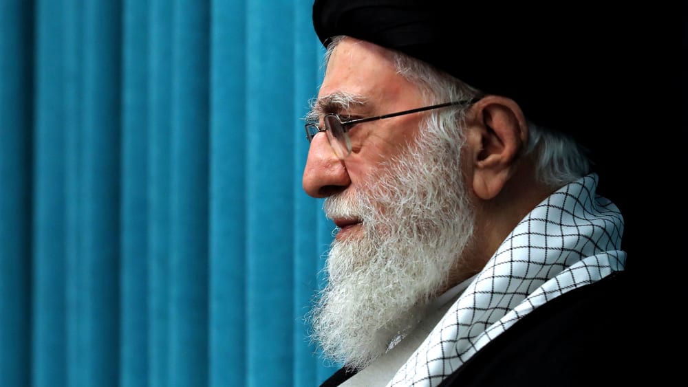 A profile view of a bearded man with a turban