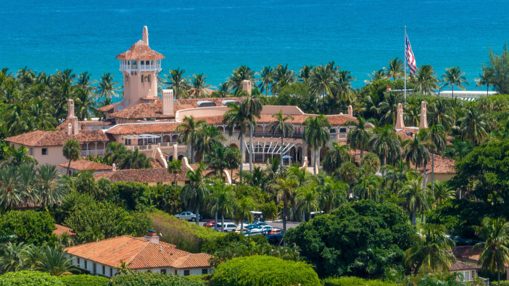 Mar-a-Lago is seen in the distance in front of the sea.