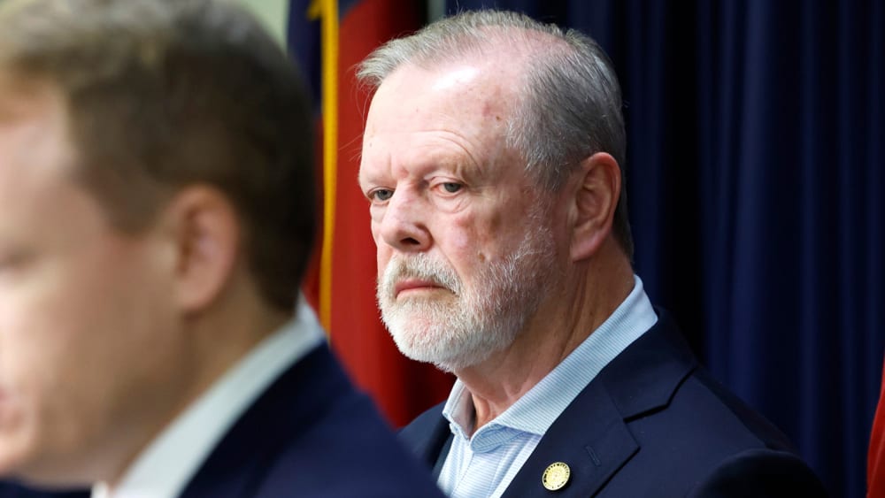 Phil Berger stands behind as he looks on in an upset way.