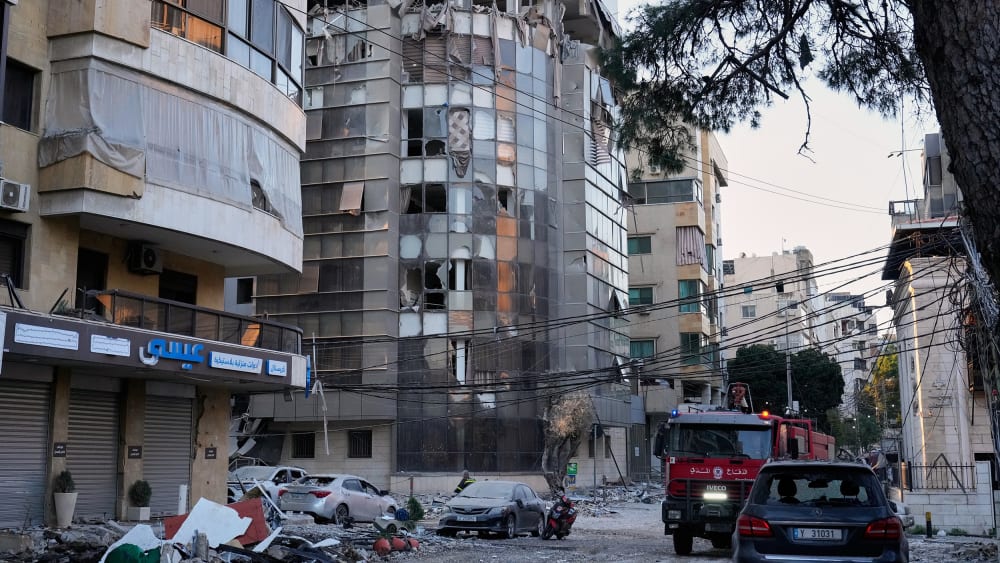 Debris covers a street beside an apartment building hit by an Israeli airstrike in Dahiyeh, Beirut's southern suburb.