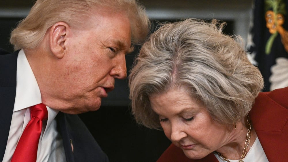 President Donald Trump leans in to speak with White House Chief of Staff Susie Wiles at the White House.