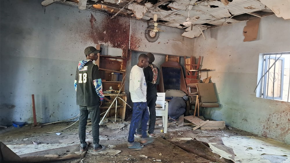 People inspect the scene of a deadly bomb explosion inside a mosque on Dec. 25 in Maiduguri, Nigeria.