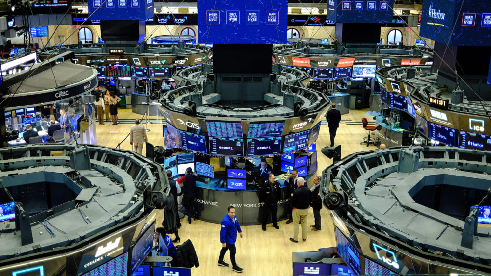 Traders work on the floor of the New York Stock Exchange at the opening bell in New York.