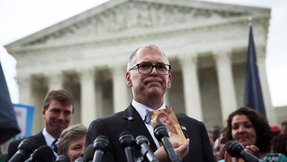 Plaintiff Jim Obergefell holds a photo of his late husband, John Arthur, as he speaks to members of the media on June 26, 2015, in front of the Supreme Court.
