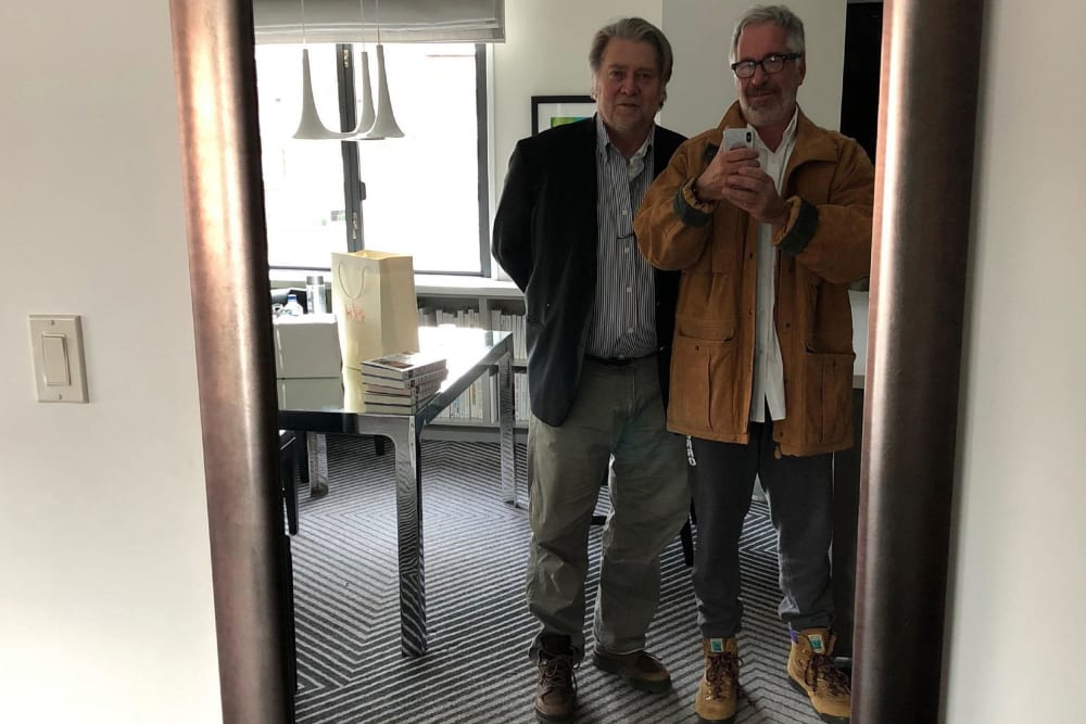 Jeffrey Epstein, right, takes a mirror selfie of him and Steve Bannon.