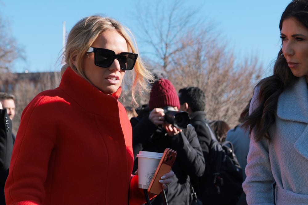 Trisha McLaughlin talks to Kristi Noem as they walk away.