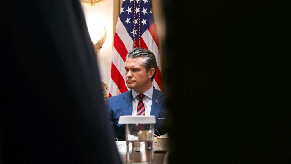 Pete Hegseth is seen looking serious and upset.