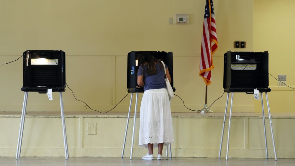 Woman fills out her ballot as she votes on Nov. 03, 2020 in Miami.