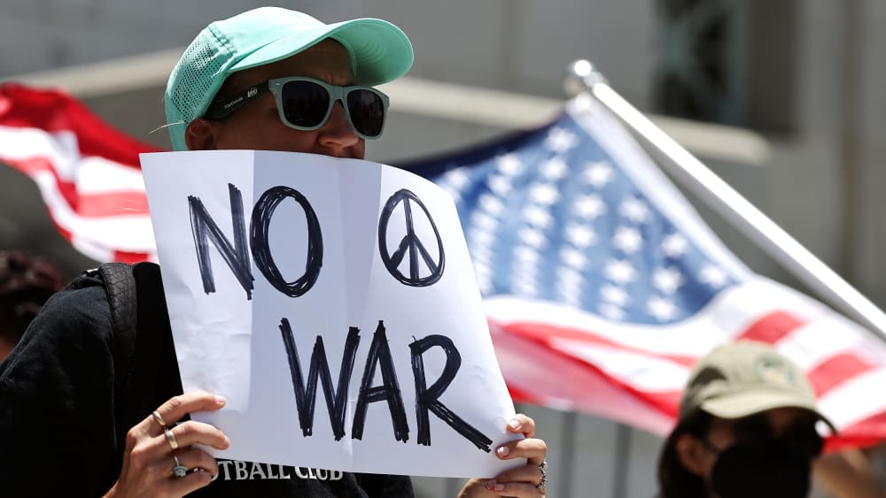 Demonstrators gather outside City Hall during a rally opposing the United States' strikes on Iran on June 22, 2025.