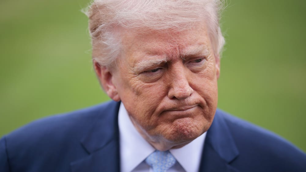 President Donald Trump stops to speak to reporters.