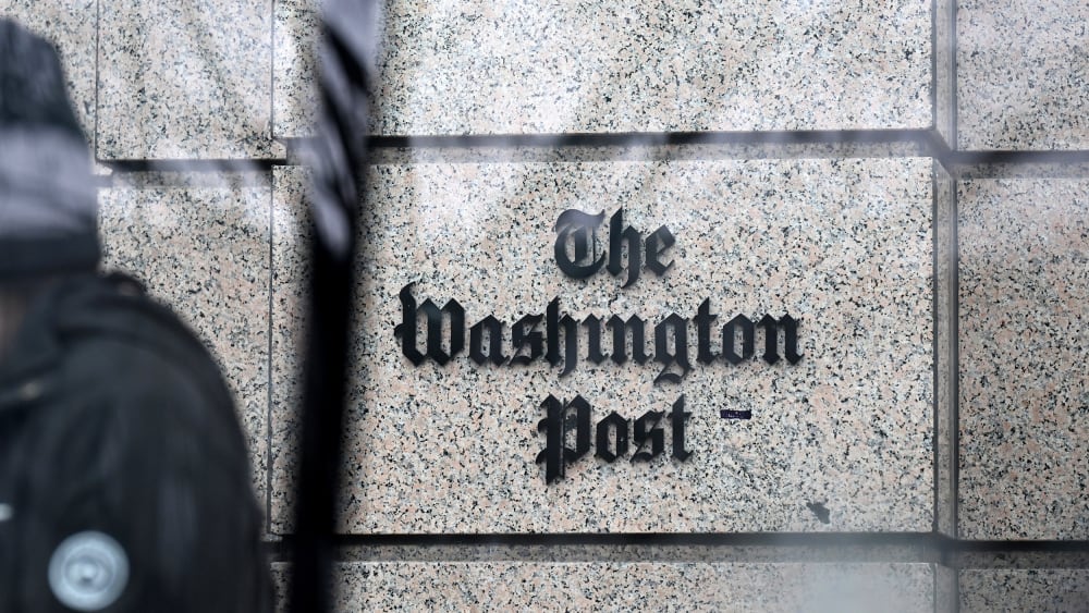 The Post sign is visioble through a glass