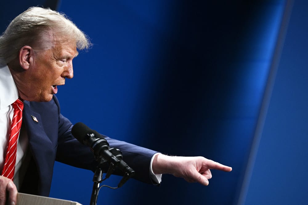 President Donald Trump gestures as he gives a press conference.