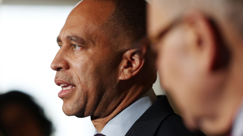 Hakeem Jeffries is talking while Chuck Schumer stands next to him.