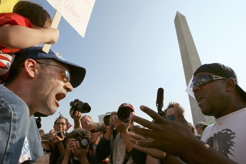 Two men shout at each other in this photo shot from below.