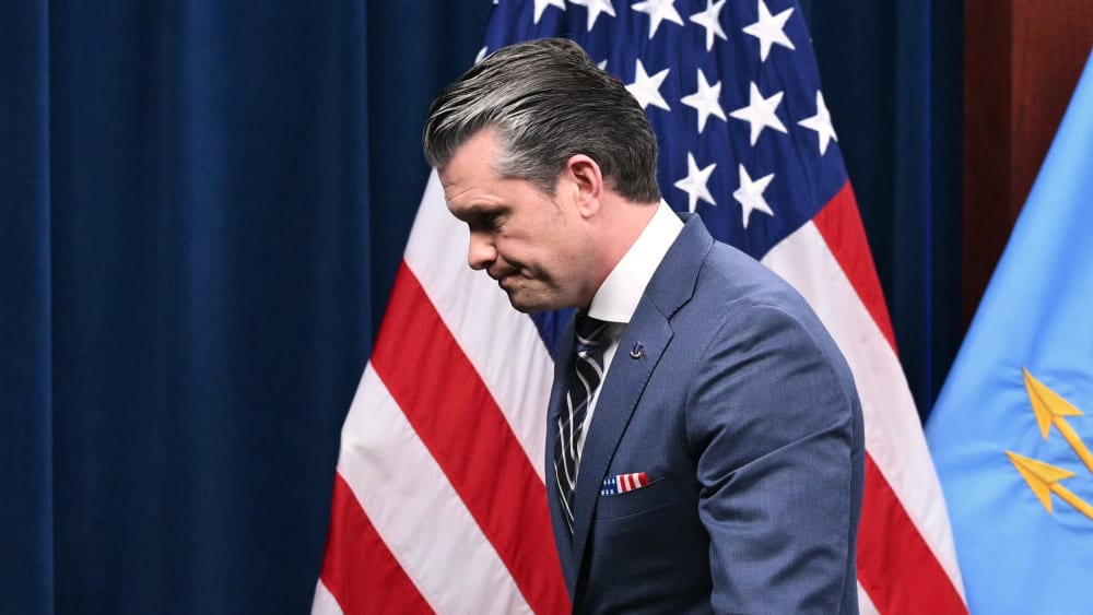 Pete Hegseth walks out to the left of the frame.